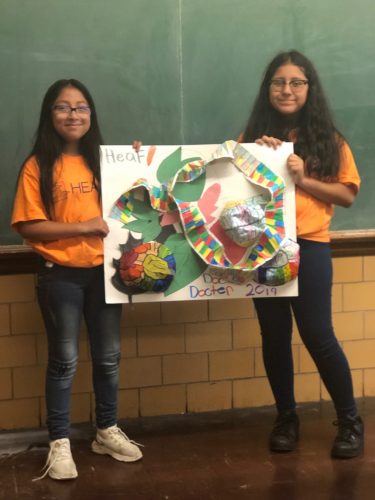 Two HEAF middle school students proudly display their project
