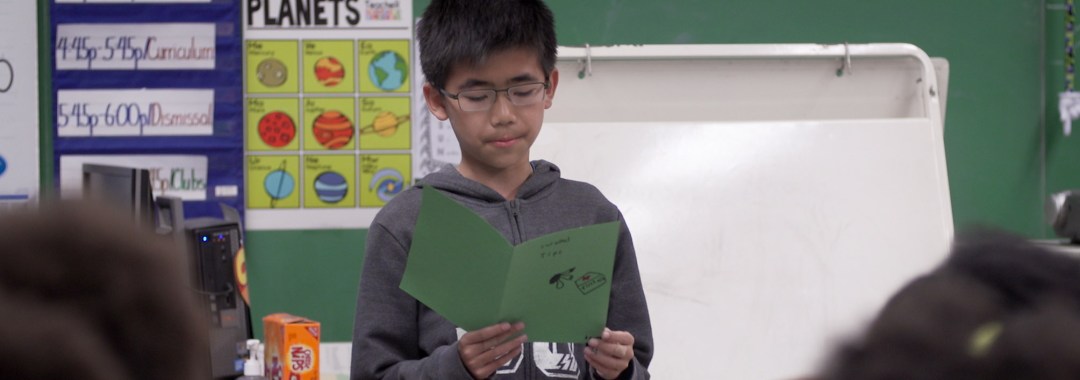 A HEAF student reads aloud to his class
